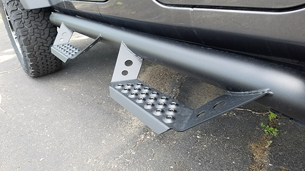 Powder-coated stainless steel drop-down steps.  These steps were born to go off-roading.